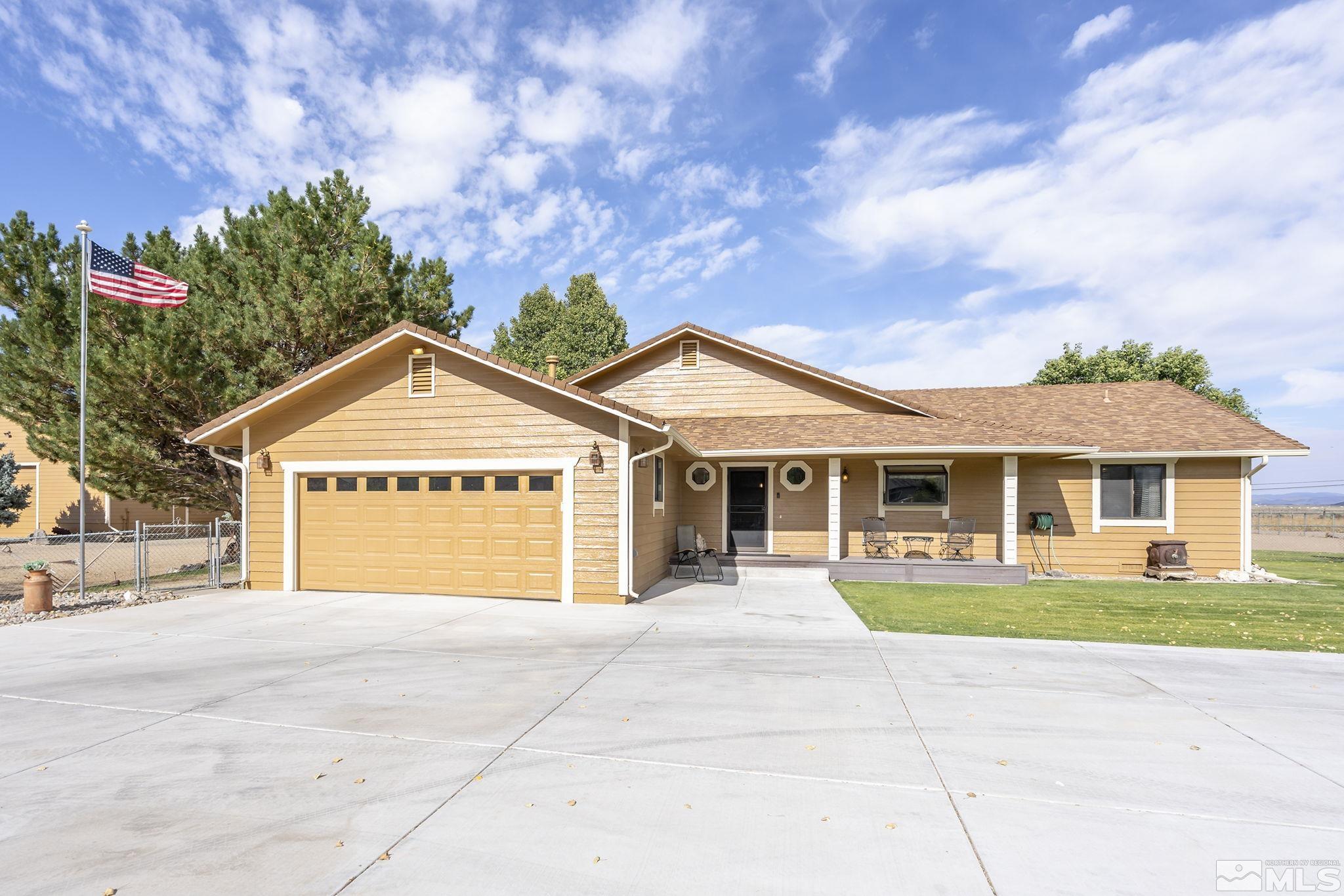 10890 Osage Road Reno, NV 89508 - Photo 1 of 40 a view of a house with a yard and potted plants