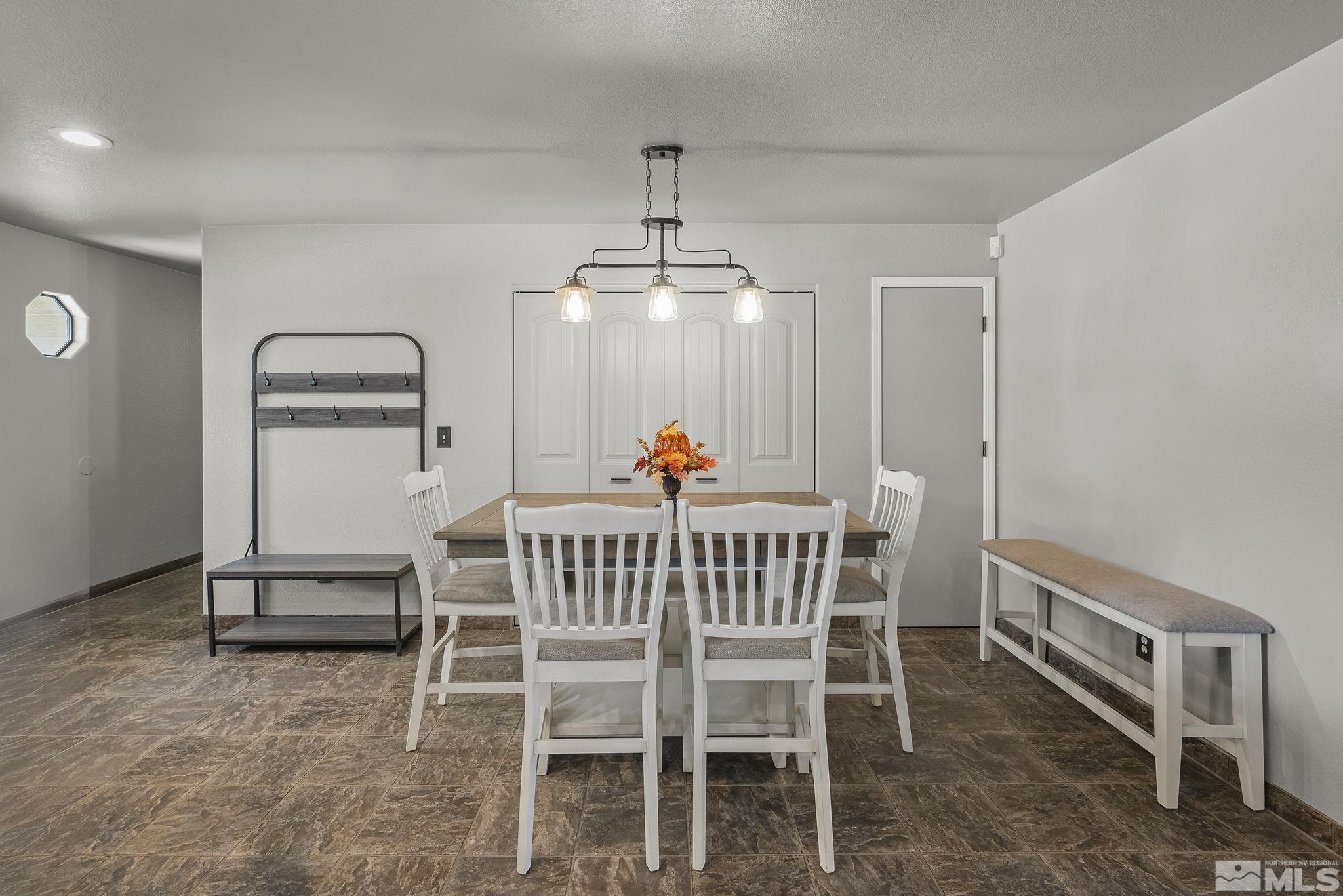 10890 Osage Road Reno, NV 89508 - Photo 11 of 40 a dining room with a wooden table and chairs