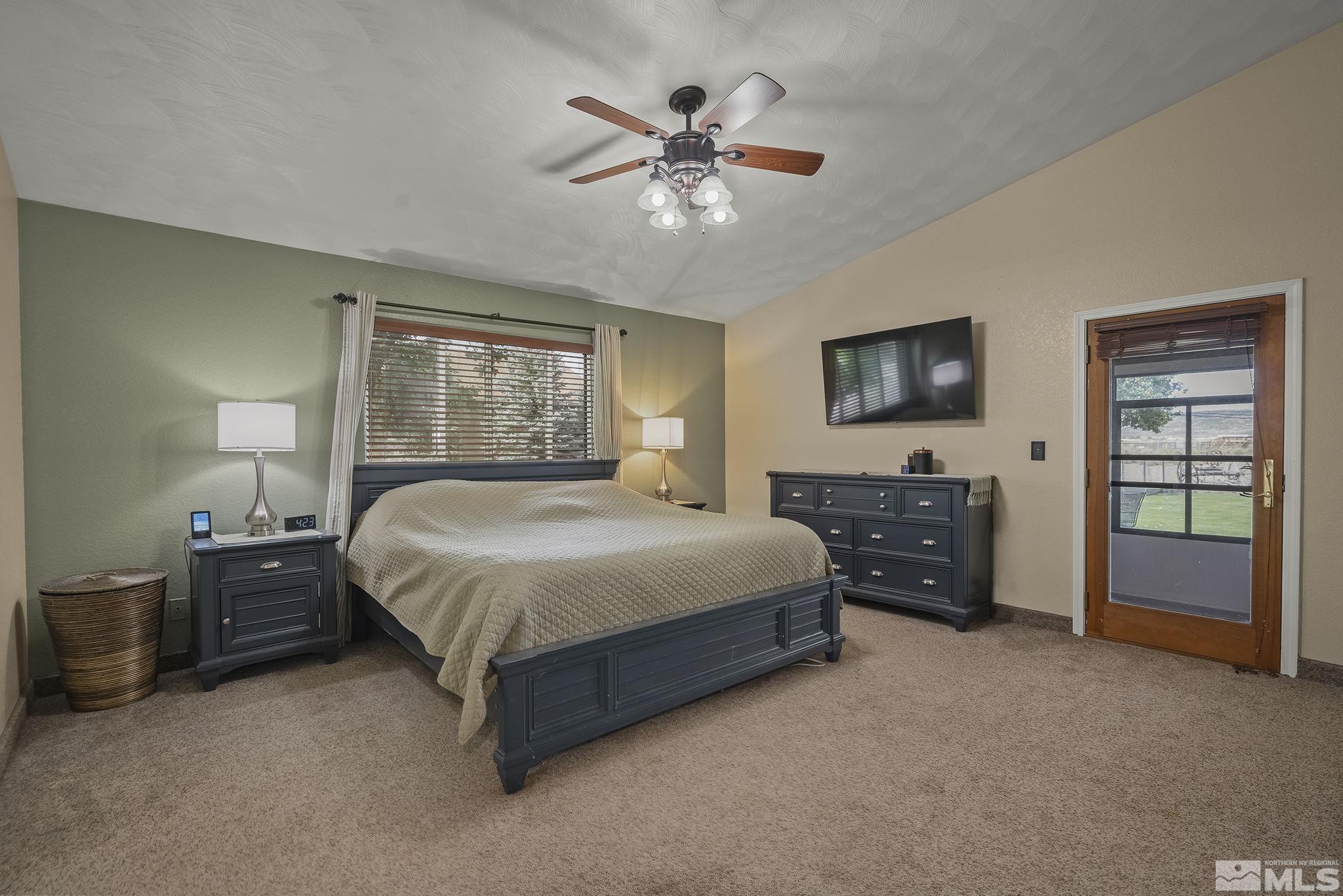 10890 Osage Road Reno, NV 89508 - Photo 15 of 40 a spacious bedroom with a bed and a flat tv screen on dresser