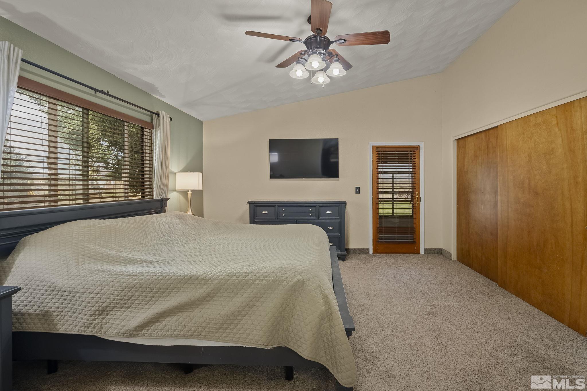10890 Osage Road Reno, NV 89508 - Photo 17 of 40 a bedroom with a bed and a flat screen tv