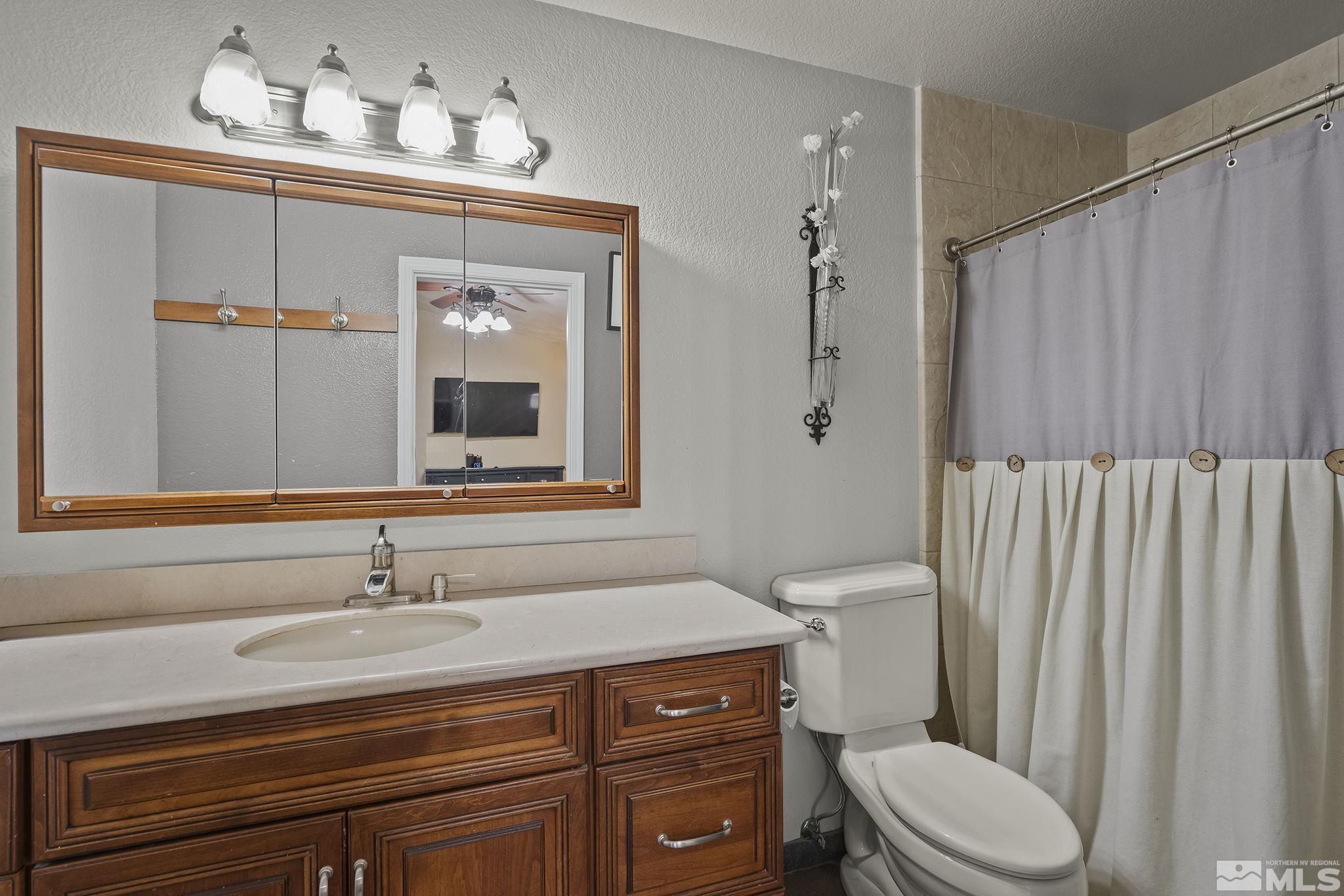 10890 Osage Road Reno, NV 89508 - Photo 18 of 40 a bathroom with a sink a toilet and shower