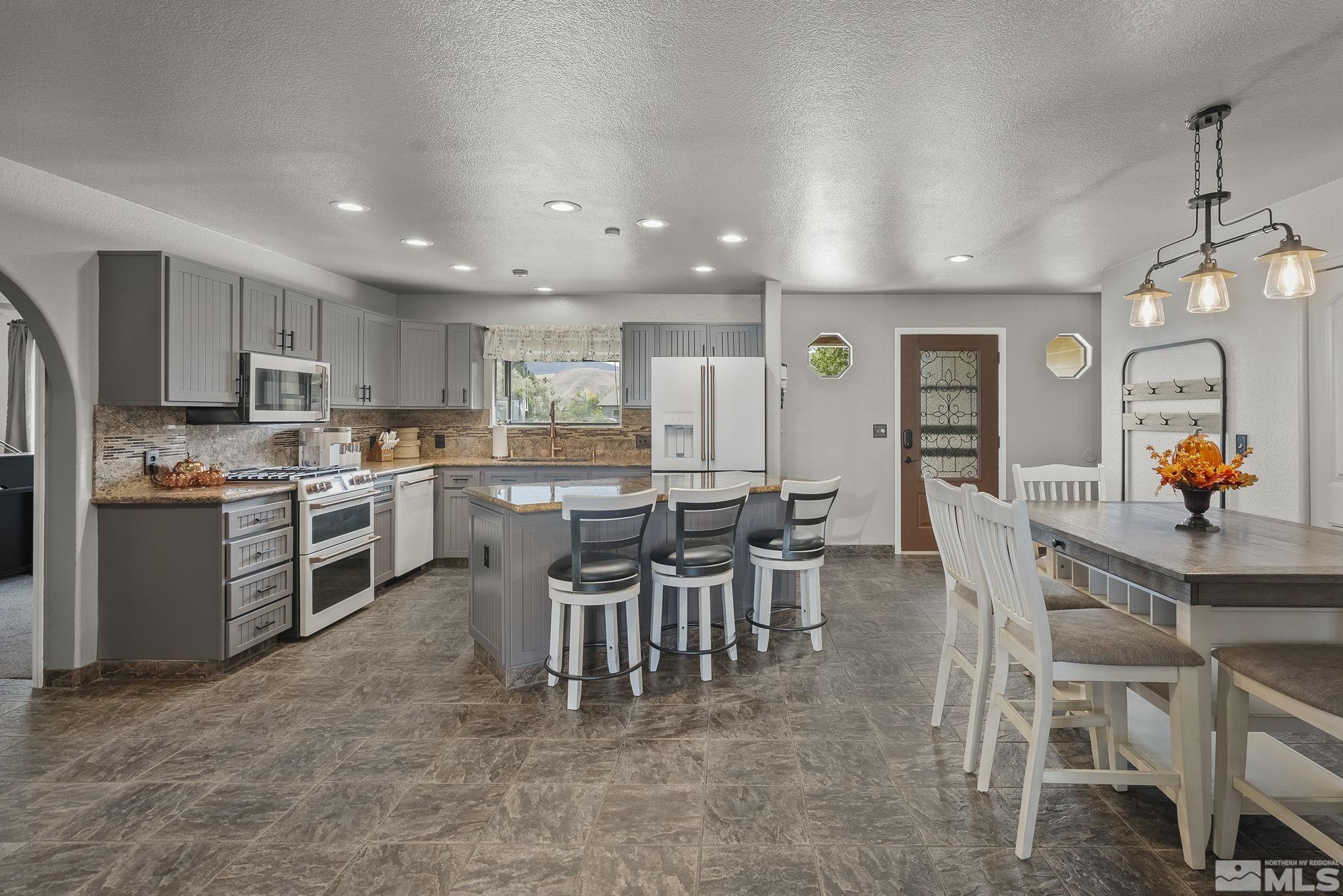 10890 Osage Road Reno, NV 89508 - Photo 6 of 40 a view of kitchen with cabinets table and chairs