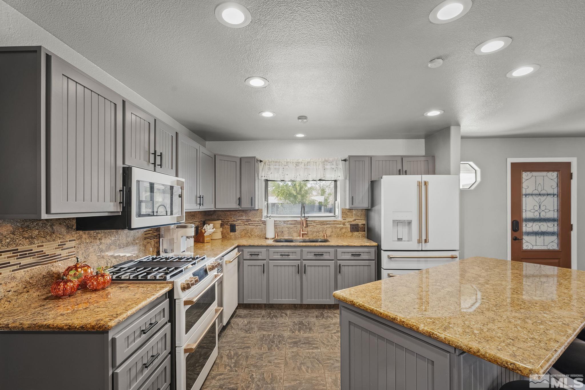 10890 Osage Road Reno, NV 89508 - Photo 7 of 40 a kitchen with refrigerator and cabinets