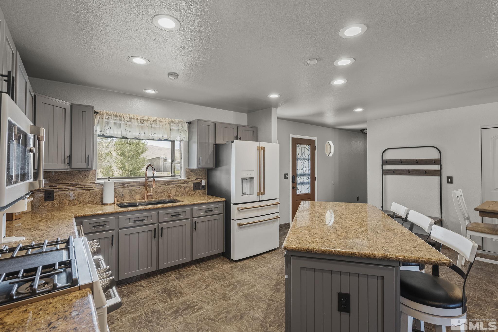10890 Osage Road Reno, NV 89508 - Photo 8 of 40 a kitchen with a sink and refrigerator