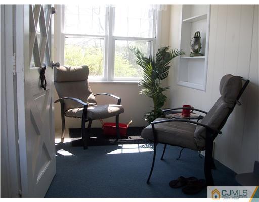 13 Yellowbrook Road Monmouth County, NJ 07728 - Photo 3 of 10 a living room with furniture and a potted plant