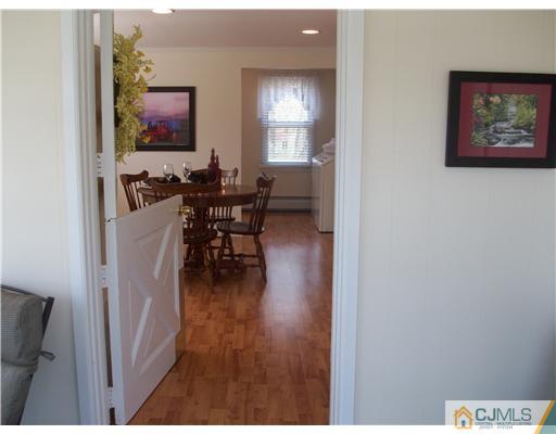 13 Yellowbrook Road Monmouth County, NJ 07728 - Photo 4 of 10 a view of a dining room with furniture and wooden floor