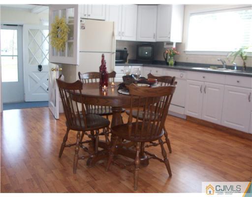 13 Yellowbrook Road Monmouth County, NJ 07728 - Photo 5 of 10 a view of a dining room with furniture and wooden floor