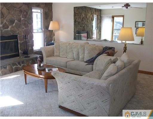 13 Yellowbrook Road Monmouth County, NJ 07728 - Photo 7 of 10 a living room with furniture and a fireplace