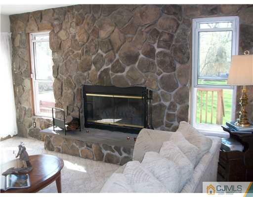 13 Yellowbrook Road Monmouth County, NJ 07728 - Photo 8 of 10 a living room with furniture and a fireplace