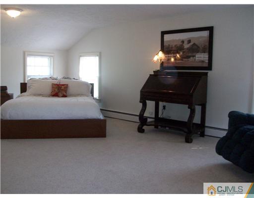 13 Yellowbrook Road Monmouth County, NJ 07728 - Photo 10 of 10 a bedroom with a bed and a painting on the wall