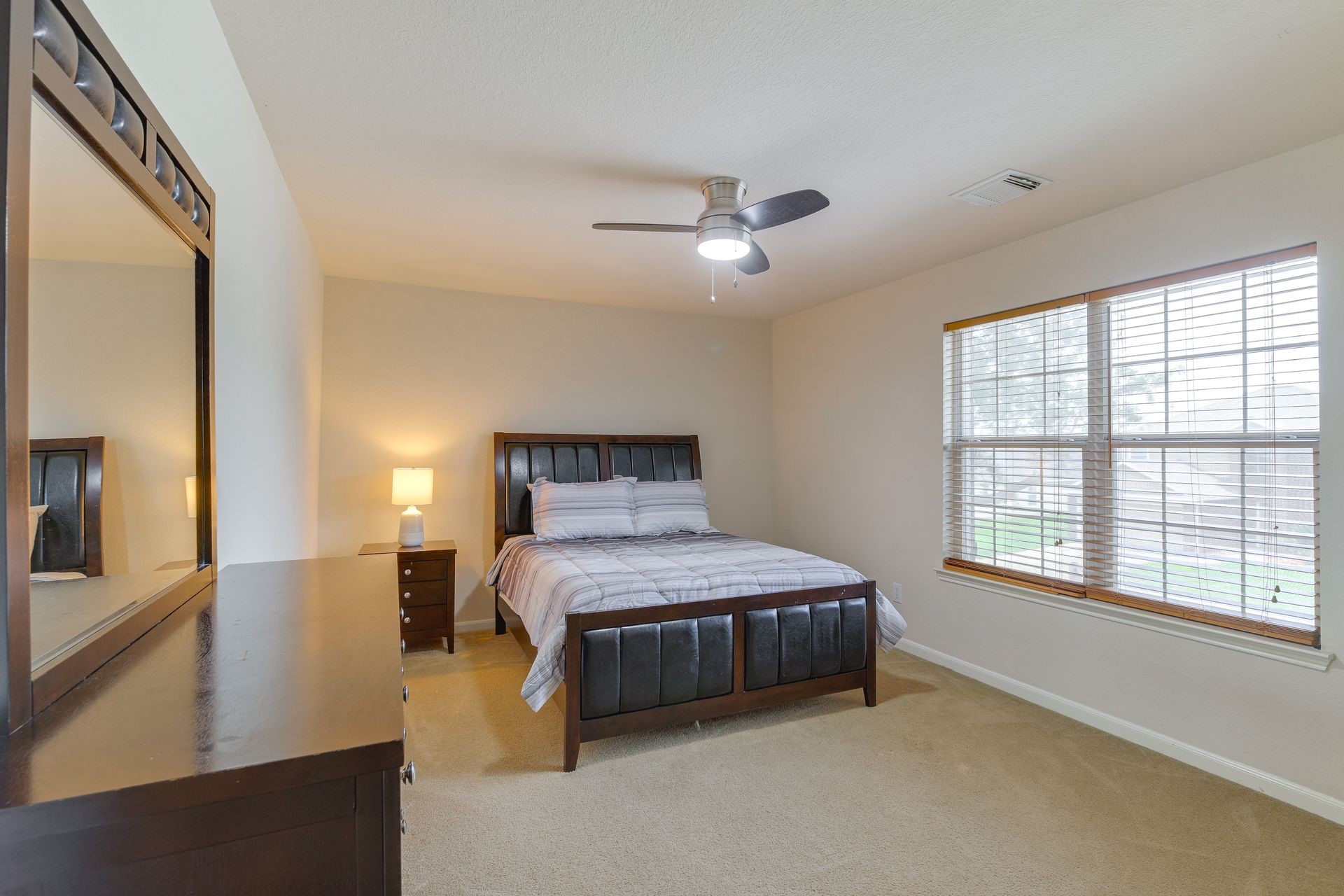 8019 Berkely Court Baytown, TX 77521 - Photo 11 of 13 a bedroom with a large bed and a chandelier