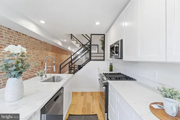 a kitchen with a sink a stove and cabinets
