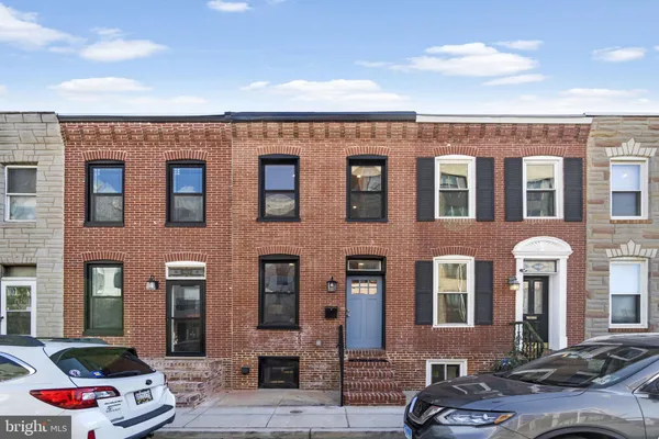 a front view of a building with parking space