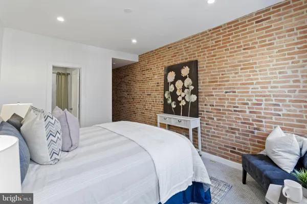 a bedroom with a bed and a chair