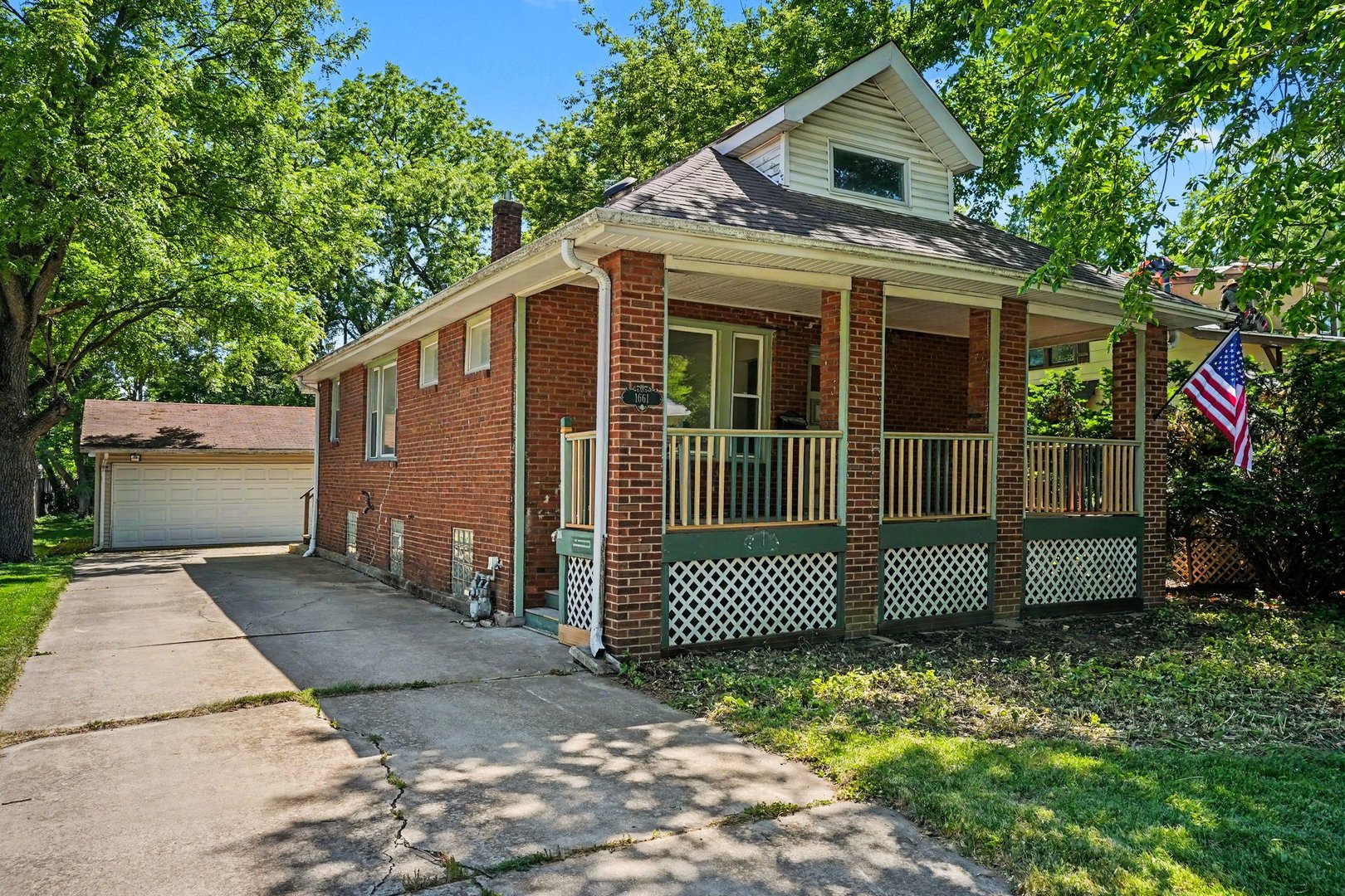 1661 Burr Oak Road Homewood, IL 60430 - Photo 1 of 17 a front view of a house with a garden