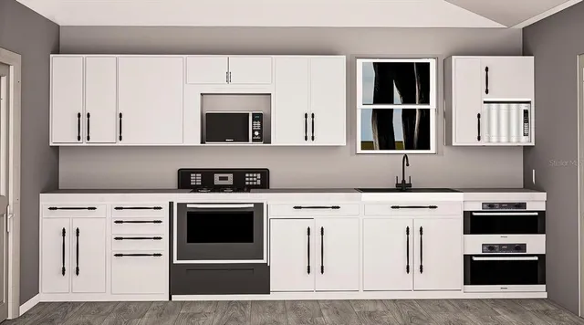 a kitchen with cabinets and appliances