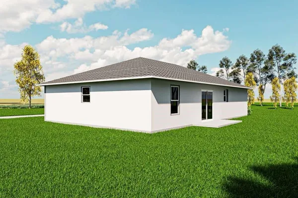 a white house with a small yard and big trees