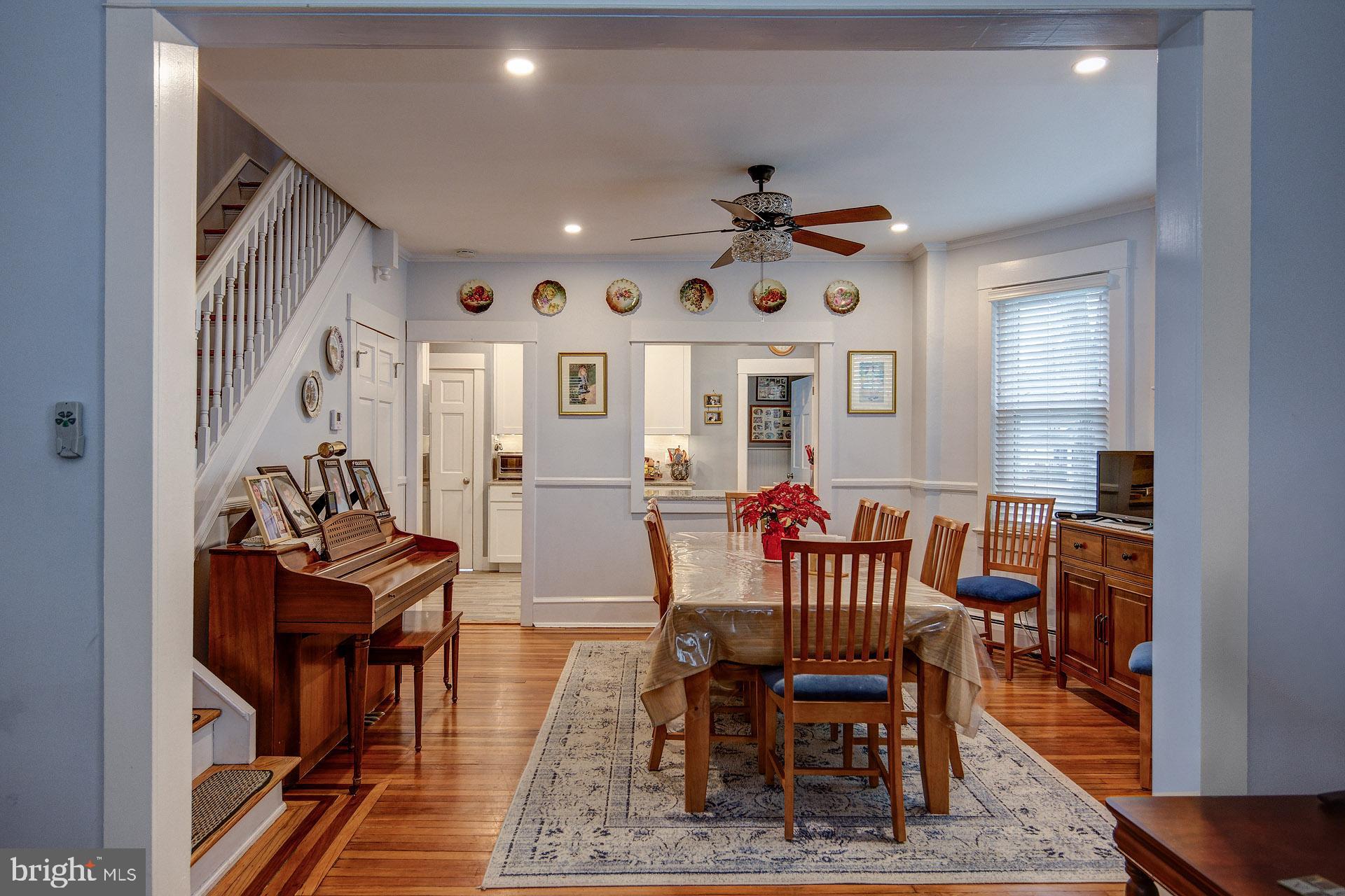 13 West Euclid Avenue Haddonfield, NJ 08033 - Photo 14 of 45 a dining room with wooden floor and a chandelier