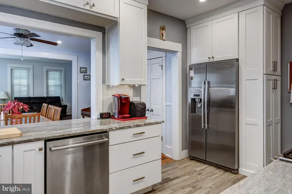 a kitchen with kitchen island granite countertop appliances cabinets and a counter top space