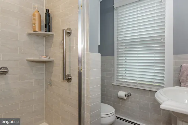 a bathroom with a toilet a sink and shower