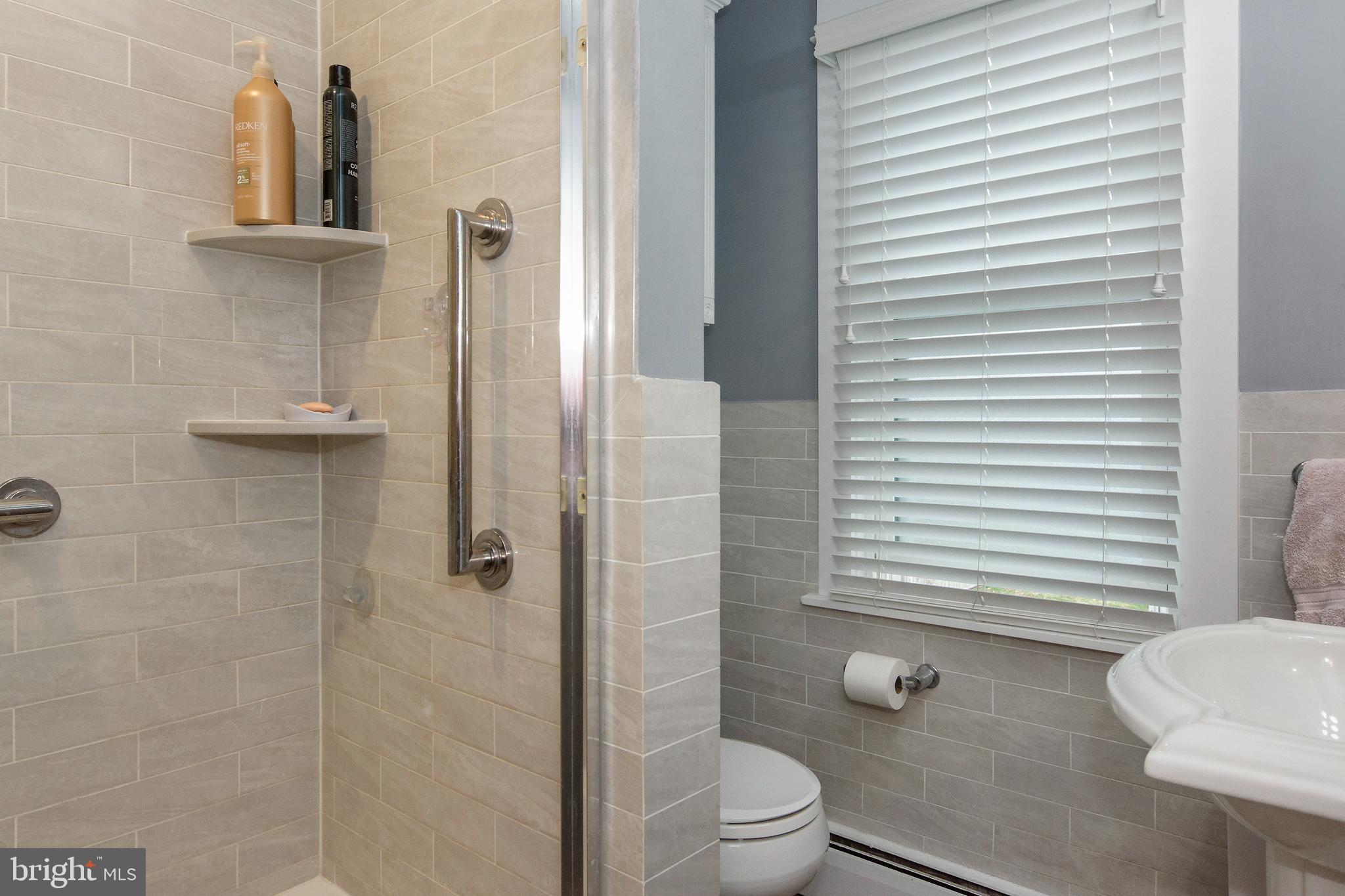 13 West Euclid Avenue Haddonfield, NJ 08033 - Photo 27 of 45 a bathroom with a toilet a sink and shower