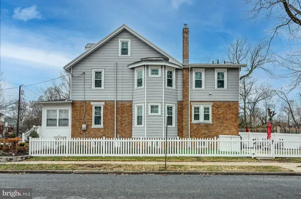 a front view of a house with a fence