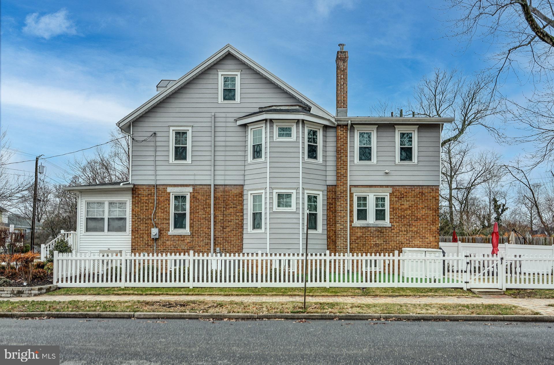 13 West Euclid Avenue Haddonfield, NJ 08033 - Photo 3 of 45 a front view of a house with a fence