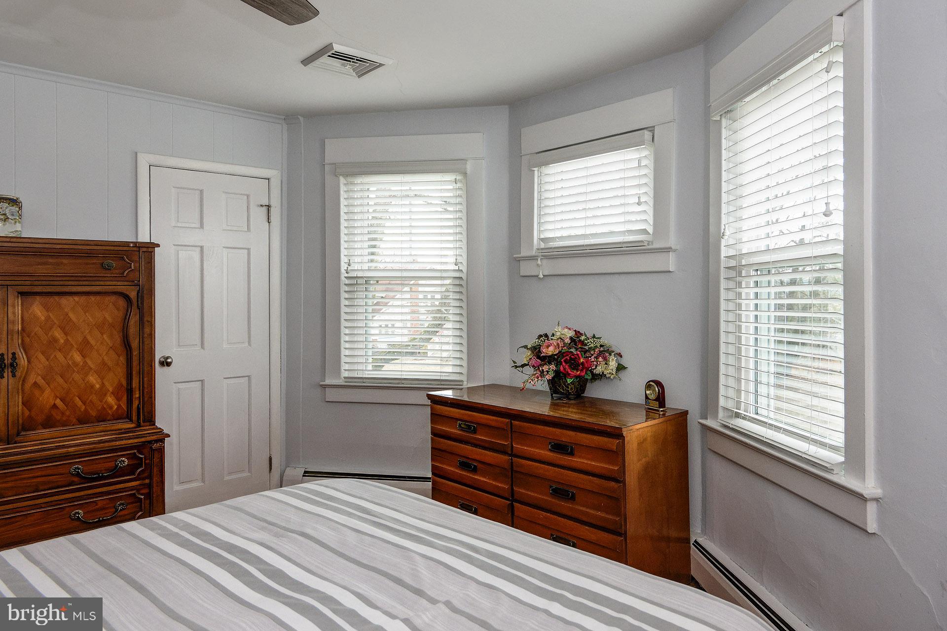13 West Euclid Avenue Haddonfield, NJ 08033 - Photo 35 of 45 a bedroom with a bed and wooden floor