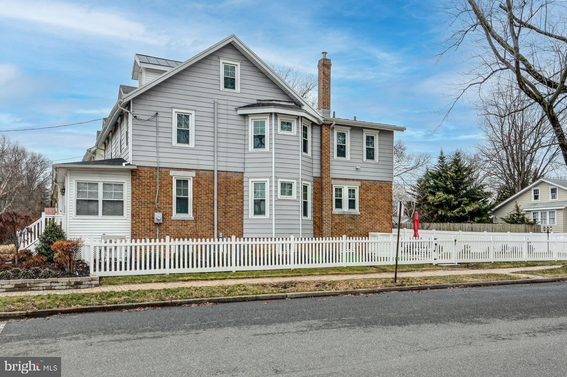 13 West Euclid Avenue Haddonfield, NJ 08033 - Photo 4 of 45 a front view of a house with a yard