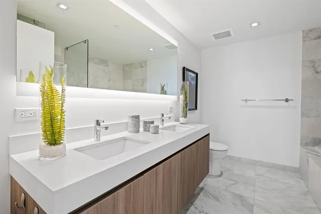 a spacious bathroom with a bathtub and shower