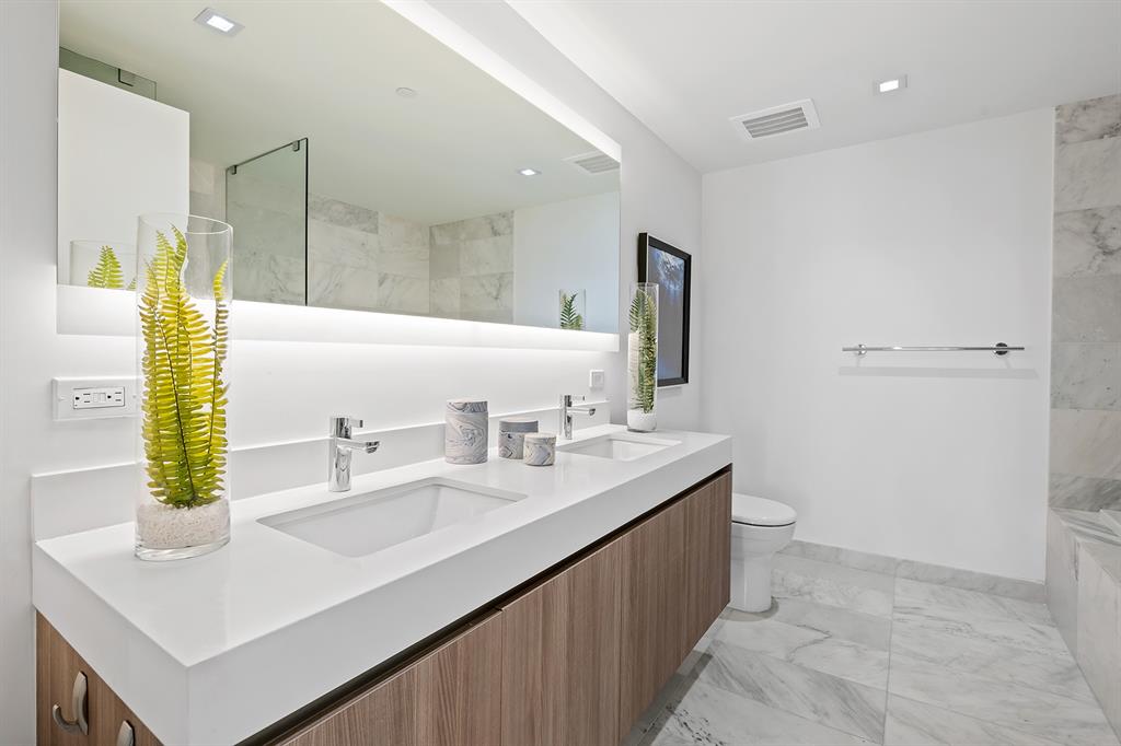 401 North Birch Road, Unit 1003 Fort Lauderdale, FL 33304 - Photo 12 of 26 a bathroom with a sink double vanity and a mirror