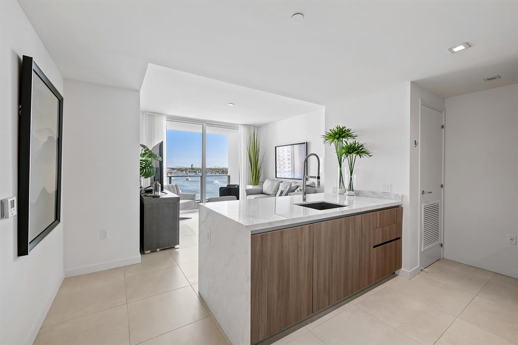 401 North Birch Road, Unit 1003 Fort Lauderdale, FL 33304 - Photo 3 of 26 a kitchen with kitchen island a sink stove and refrigerator