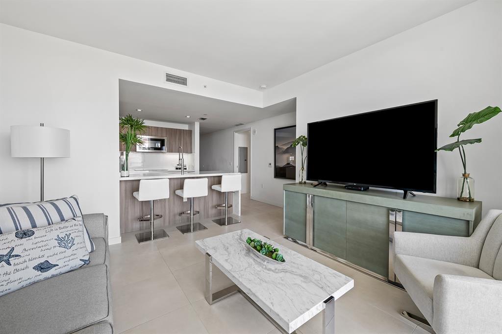 401 North Birch Road, Unit 1003 Fort Lauderdale, FL 33304 - Photo 6 of 26 a living room with furniture and a flat screen tv