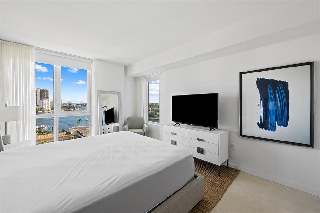 401 North Birch Road, Unit 1003 Fort Lauderdale, FL 33304 - Photo 8 of 26 a bedroom with a bed and a flat screen tv