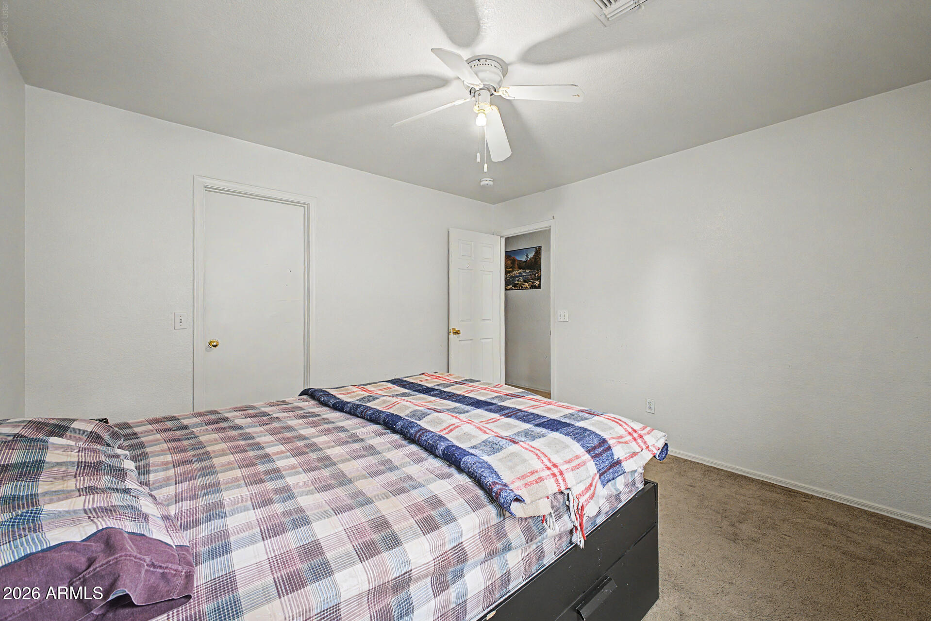 2607 West Bloch Road Phoenix, AZ 85041 - Photo 23 of 34 a bedroom with a bed and a chandelier