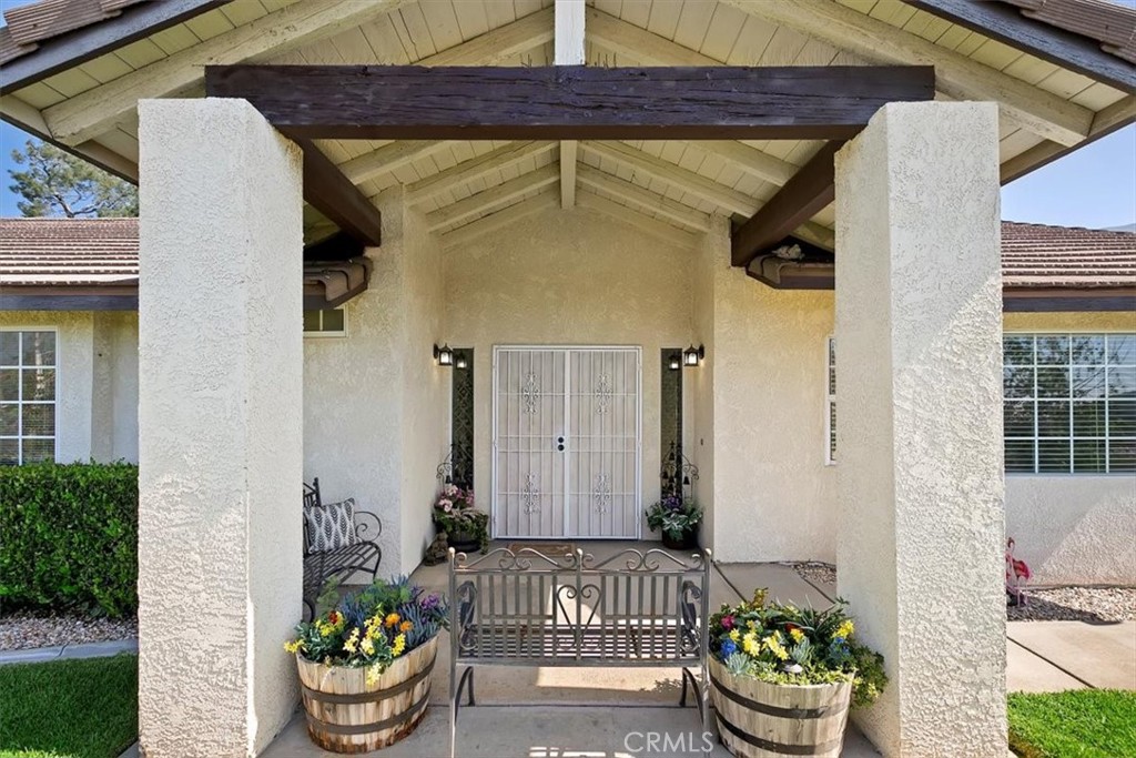 923 Devore Road San Bernardino, CA 92407 - Photo 11 of 75 a front view of a house with a potted plant and a patio
