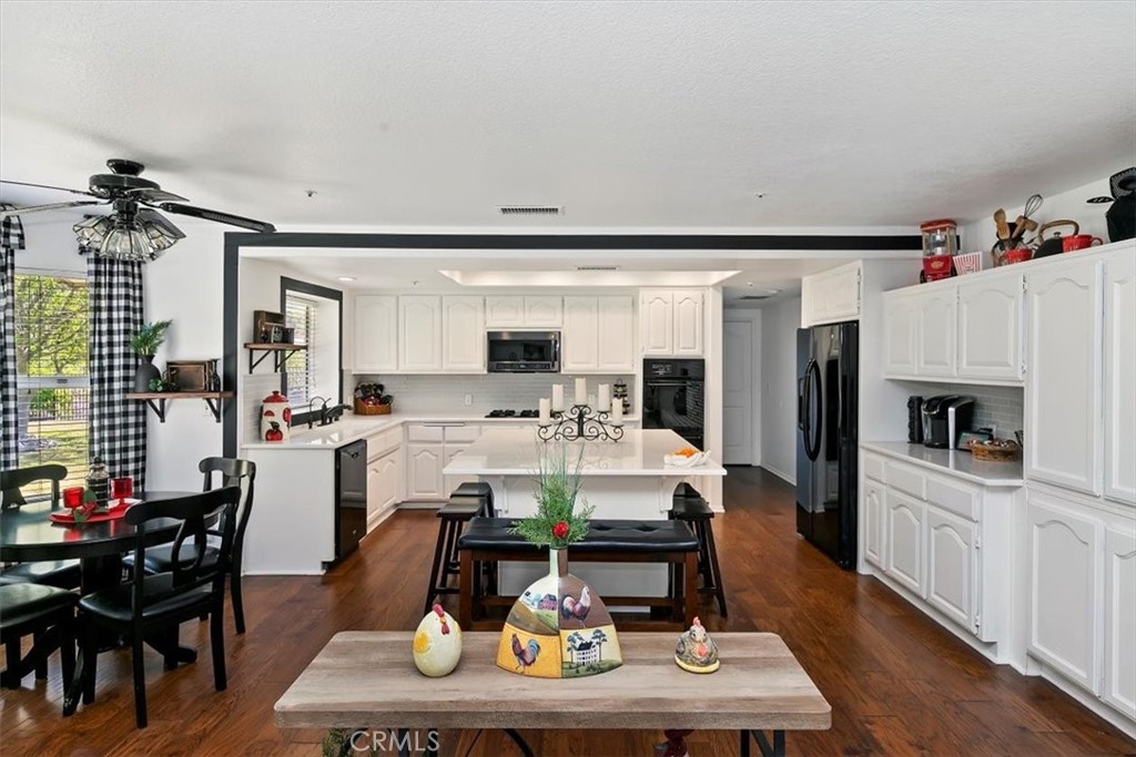 923 Devore Road San Bernardino, CA 92407 - Photo 24 of 75 a living room with furniture a rug kitchen view and a large window
