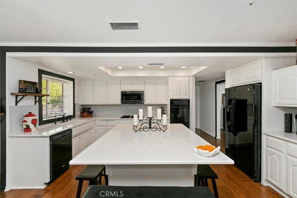 923 Devore Road San Bernardino, CA 92407 - Photo 26 of 75 a large kitchen with sink a refrigerator and chairs