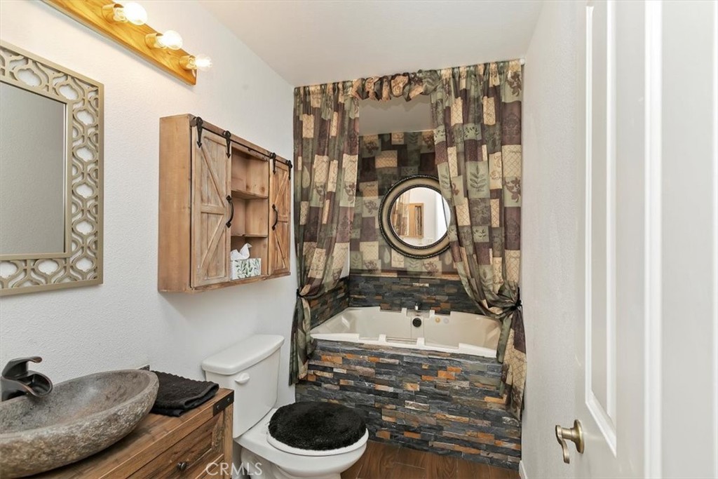 923 Devore Road San Bernardino, CA 92407 - Photo 42 of 75 a bathroom with a sink a toilet and a mirror