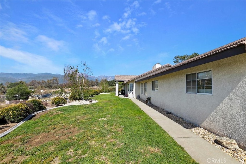 923 Devore Road San Bernardino, CA 92407 - Photo 7 of 75 a backyard of a house with plants and large trees