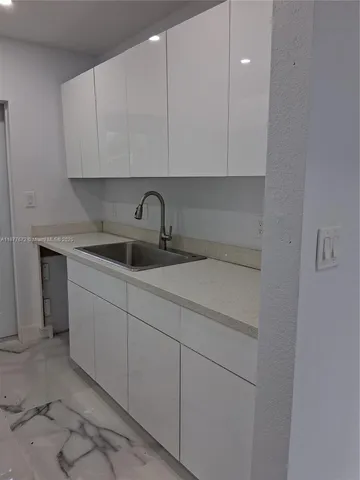 a kitchen with a sink and cabinets