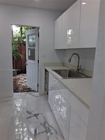 a kitchen with a sink and cabinets