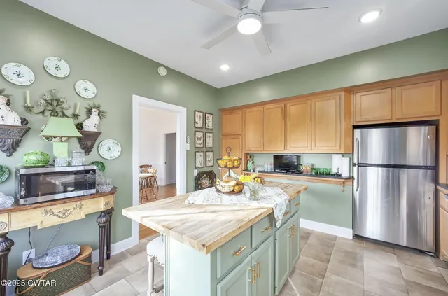 a view of a hallway with wooden floor and furniture