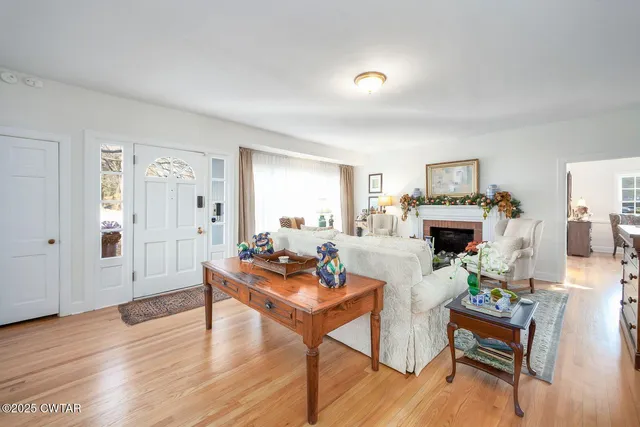 a living room with furniture a fireplace and a table