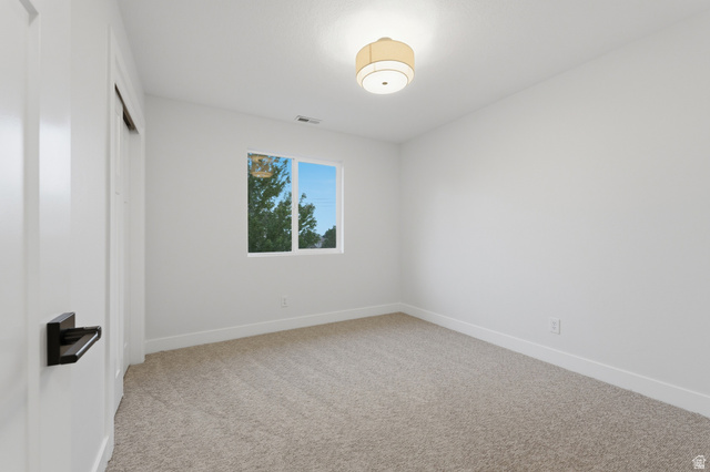 702 Alpine Highway Alpine, UT 84004 - Photo 45 of 83 Room featuring neutral tone carpeting, white walls, and a single window with white trim