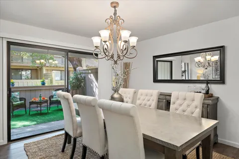 a living room with furniture a table and a large mirror