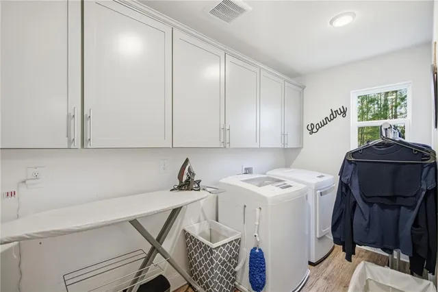 a room with a table chairs and a window