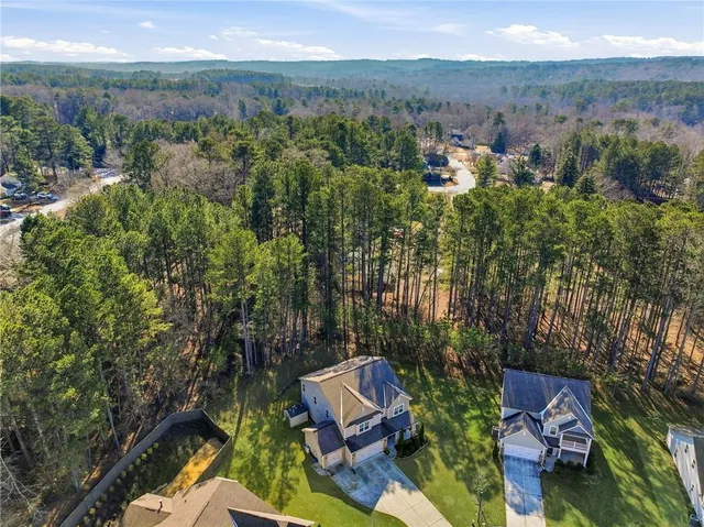 an aerial view of a house with a yard