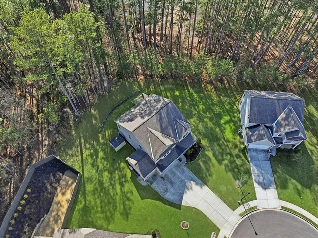 an aerial view of a house with a yard