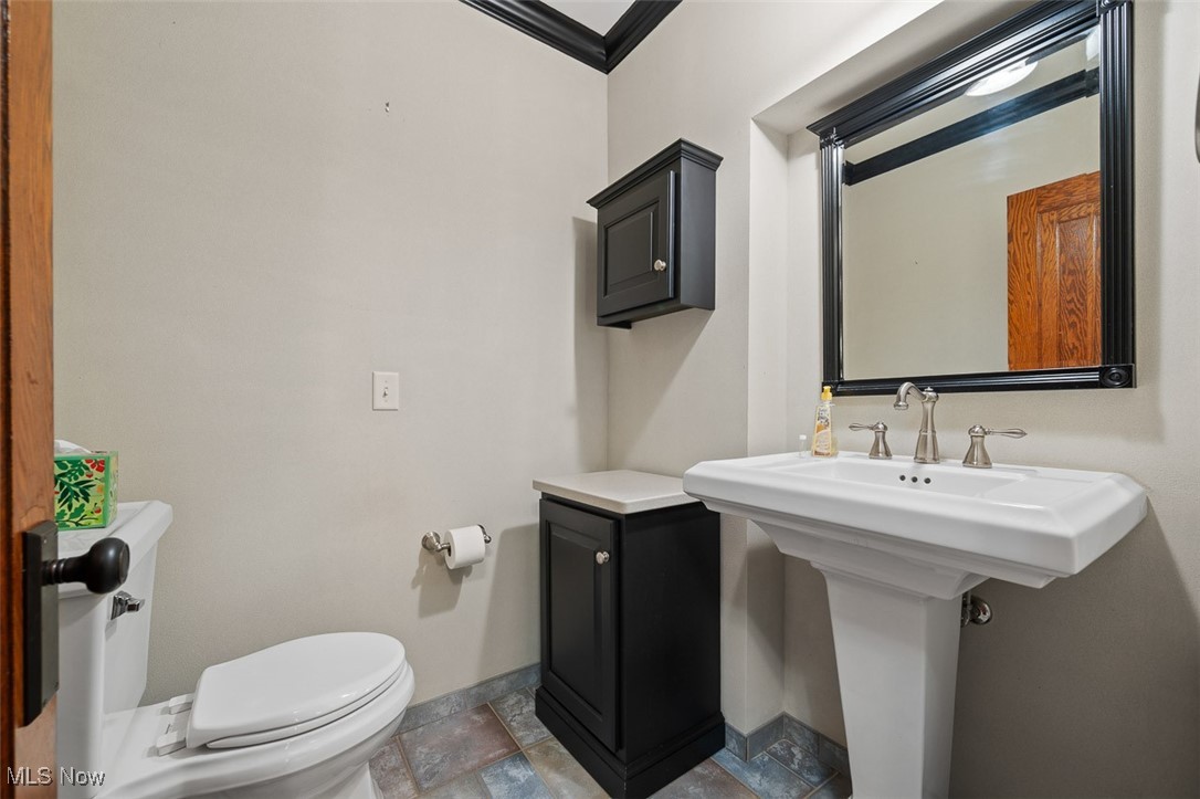 256 Everhard Road Southwest North Canton, OH 44709 - Photo 12 of 45 Half bath featuring crown molding and toilet